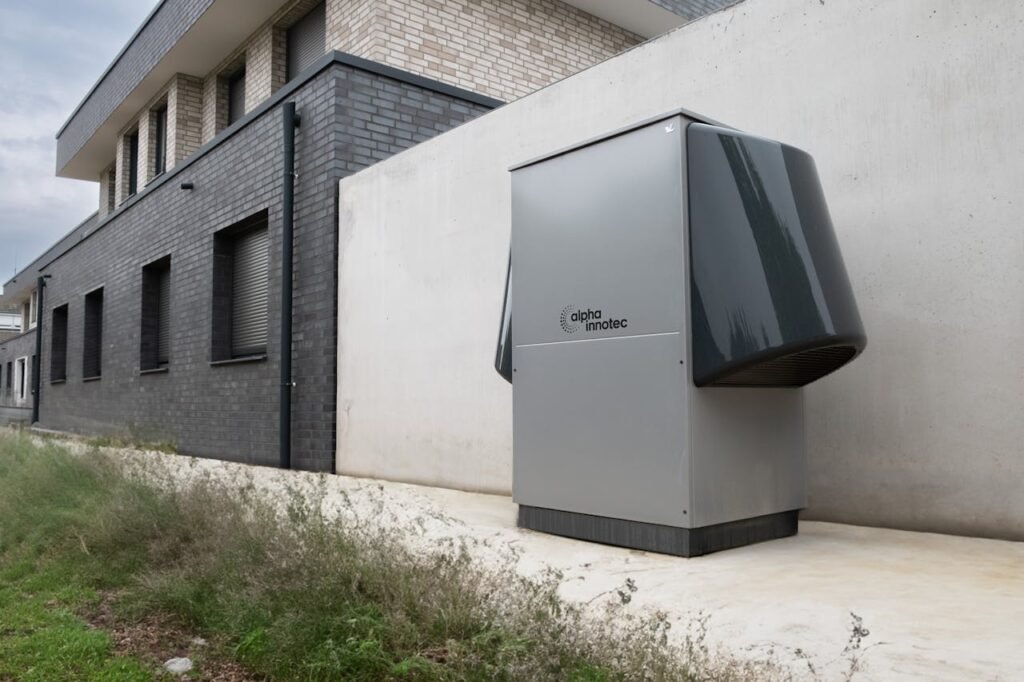 Innovative heat pump system by alpha innotec installed outside a contemporary building.